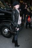 Miley Cyrus in black leather jacket and boots